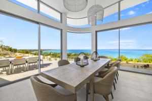 curved floor to ceiling window with ocean view