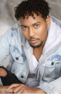 Elijah Washington, rising Hollywood talent headshot, he is posed and wearing a jean jacket and gray hoodie