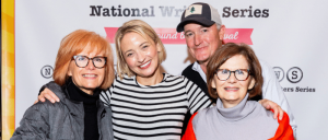 Four individuals standing together in front of a backdrop with the text "National Writers Series."