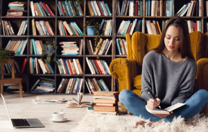 Young woman sitting on the floor studying