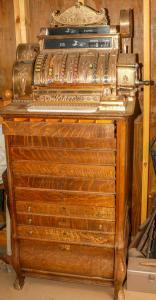 9-drawer National Cash Register (Dayton, Ohio) from 1914, in mint condition, with exquisite design and durability, having original mechanism and intricate details (est. $10,000-$15,000).