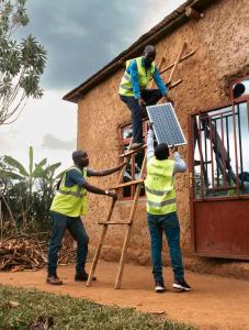 Ignite Power agents installing a Solar Home System (SHS) in a rural community, bringing clean energy to the last mile