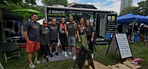 The Body Techs Wellness + Rehab team poses in front of their mobile cryo & wellness trailer at the Twin Cities Pride Festival, offering cryotherapy, compression, cryo facials, and other recovery services to the community.