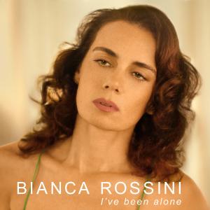 Album cover for Bianca Rossini’s I’ve Been Alone featuring the Brazilian singer in a reflective pose, symbolizing the emotional depth and journey of self-discovery explored in her first all-English language album.