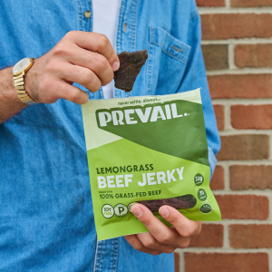 Customer holds Prevail Jerky gluten-free beef jerky snack in his hand