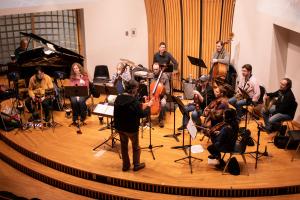 The Orchestra Rehearsing under the driection of Thomas Palance for a concerrt at Gordon Conwell college