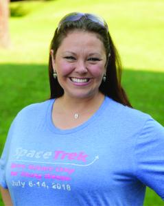 Jen Carter, Director of the Center for STEM+eXcellence at Morehead State University, poses for a photo. She is dressed professionally and smiling confidently. The background suggests an academic or professional setting.