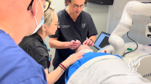 Dr. Jon Mendelsohn prepares a patient for treatment with the Artas iX Hair Robot