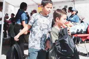 Children at the 2024 Back-to-School Backpack Event with their new backpacks