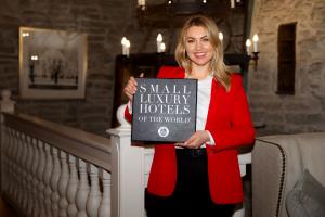 General Manager Mara Blaubarde holds the SLH wall plaque