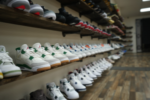 Colorful sneaker wall display featuring a variety of premium and limited-edition sneakers neatly arranged on shelves, showcasing different styles, brands, and designs.