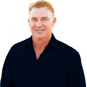 Picture of Todd Stottlemyer, 3-time MLB World Series championship winner smiling wearing a dark, pinstriped button-up shirt, standing against a white background