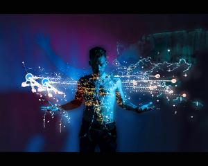 A photograph of a young man with projection of real time flights lights over a world map