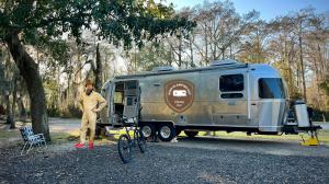 Photo of GenX Glamping Guy and his 27' Airstream Globetrotter Sporting Glampwear