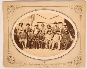 Mounted original albumen photo from 1881 of 13 men who made up a posse sent from Tucson to Yuma to take over the goods from a suspected huge retail goods swindle ($2,750).