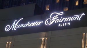 Illuminated outdoor sign for Fairmont Austin, showcasing the rebranding to Fairmont Manchester, installed by Royal Signs & Awnings on the hotel's facade