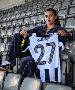 Elysia Boddy, midfielder, Newcastle United WFC, holding her team shirt