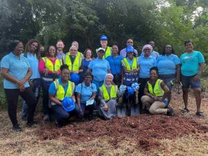 EAB, FFTP, UpMobility, The Archdiocese, and Local Community Members Pose at the future site of Zion Entrepreneurial Village