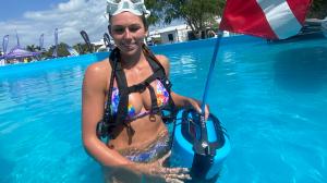 Person diving BLU3 Nomad battery-powered dive system in the AquaZone pool for live demonstrations with Nautical Ventures at the Miami Boat Show 2025.