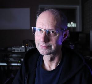 image of man with glasses in dark studio