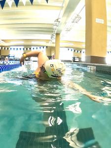 woman swimming inddors at a pool