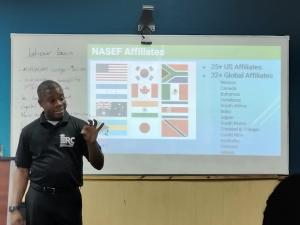 Male teacher standing in front of a room