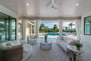 Outdoor living area of 6536 Highcroft Drive with a pool, spa, fire pits and an outdoor kitchen for entertaining.