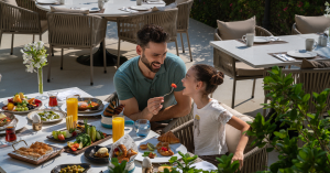 Father and daughter having breakfast at Rixos The Palm