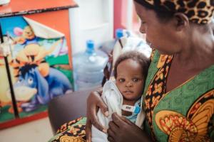 A Ugandan mother cuddles her baby hoping she will be able to have life saving heart surgery.