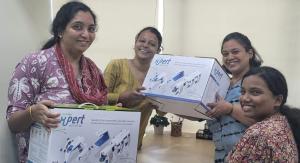 Synphne - picture shows smiling therapists holding the SynPhNe device