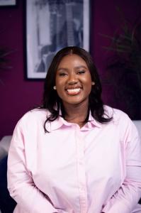 Tolulope Ola-Adejumo, a maternal health advocate and author, smiling warmly in a professional portrait. She is dedicated to supporting NICU families through advocacy and storytelling.