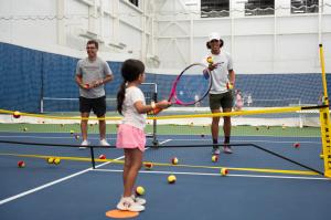 Little girl playing tennis