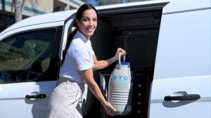 CryoFuture courier placing a cryotank in a vault retrofitted in a van.