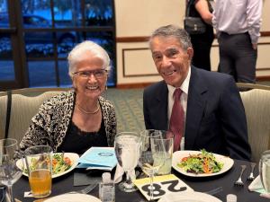 A man and woman sitting at a table smiling