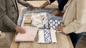 Ballard Designs design consultant assists a customer with custom fabric samples.