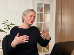 A woman actively speaking during an online call