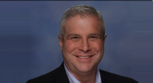 Man in dark suit smiling