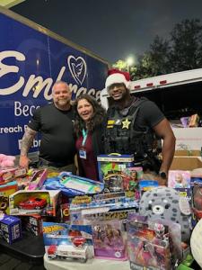 Sheriff's Deputies spreading holiday joy by handing out toys to children during the Christmas giveaway.