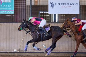 two arena polo players on horses vie for the ball during U.S. Open Arena Polo Championship