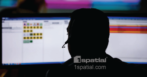 911 Operator at Screen with 1Spatial Logo Overlay