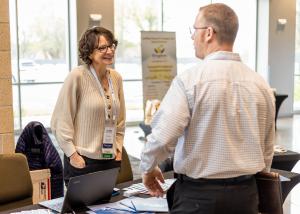 Photo of exhibitors and attendees interacting at True Charity Summit