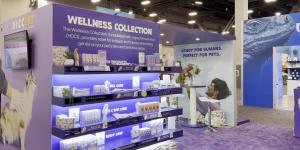 a section of the hicc pet booth at superzoo 2024 which is made up of purple walls with shelves of products and purple carpet