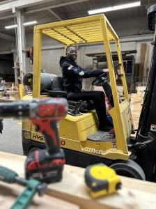 Chasity Glosson, a participant enrolled in WRTP | BIG STEP's YouthBuild program, practices driving a forklift at WRTP | BIGSTEP's Milwaukee training center as part of her certified pre-apprenticeship training.