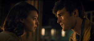 Film still of a man and a woman looking at each other.