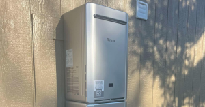 Tankless water heater installed on the exterior of a home.