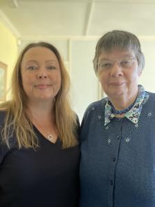 Della Judd, a woman with brown/blonde hair stands next to her aunt Helen Allinson who ha grey hair and glasses. They are both smiling
