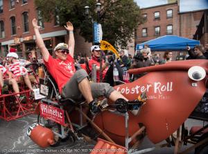 A kinetic sculpture of a lobster roll cruising down the street