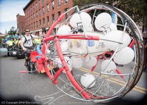 A large sphere with power ball balloon numbers rolling down the street