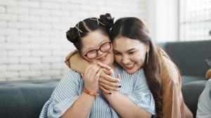 Mother hugging daughter with Down Syndrome