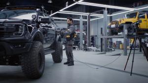 A Man Using Trackit to Scan An SUV
